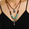 Collar Étnico Vintage de Doble Capa con Cuentas de Madera Turquesa y Cordón de Cuero, Cadena para Clavícula Bohemio Exótico con Colgante en Capas