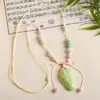 Collar con colgante de campana de mariposa de cerámica de estilo étnico retro para mujer, diseño nuevo y moderno, cadena larga para suéter, accesorios