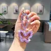 Chaveiro de borboleta oca com corrente de cristal e argila incrustada com diamantes, pingente de bolsa brilhante da moda, acessório de strass de luxo leve para mulheres