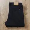 Pantalones casuales rectos holgados de negocios de sarga de lijado elástica de cintura alta para hombre, nuevos de otoño e invierno 2024, color caqui