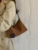 Diseño de nicho con un toque de alta gama, nuevo bolso cruzado de ante esmerilado estilo perezoso retro para el antebrazo, hombro o bandolera para mujer 2026