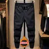 Pantalones casuales de cintura elástica de alta gama para hombre, corte ajustado, estilo coreano, modernos, negros, elásticos, finos de verano, con medio puño