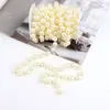Materiales de embalaje para ramos al por mayor decoración floral xiangfeng embalaje de flores cadena de perlas sintéticas accesorios de lazo