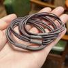 Venta directa de fábrica de cuero de alta elasticidad con cuerda para la cabeza de color negro fresco y pequeño de tres líneas, versión coreana