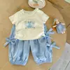 Conjunto de Desenho Animado com Laço Estilo Coreano para Meninas, Novo Conjunto de Duas Peças de Moda Verão com Manga Curta e Calça Jogger para Bebês e Crianças Pequenas