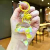 Nuevo llavero de muñeca de delfín con arena movediza relleno de aceite, colgante para mochila, decoración para bolso de pareja, regalo pequeño para venta al por mayor