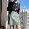 Otoño/Invierno 2026 Negro Commute Falda de Cuero Pequeña de Tiro Alto Falda Media para Mujer Falda Corta Adelgazante de Cuero PU Falda de Línea A Anti-Exposición