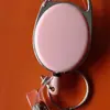 Llavero de cuero Oval transparente de color sólido retráctil con mosquetón de clip trasero hebilla de fácil extracción tirador en stock