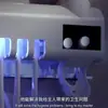 Esterilizador de cepillos de dientes inteligente directo de fábrica Portacepillos de dientes UV montado en la pared sin perforaciones Exprimidor automático de pasta de dientes