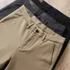 Pantalones casuales rectos de algodón modal refinado suave y cómodo de cintura media elástica para otoño e invierno, color caqui, de alta gama, ropa formal para mediana edad