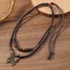 Collar con colgante de mariposa de aleación de cuerda trenzada retro de gran venta en Europa y Estados Unidos, diseño de cordón largo hecho a mano con cuentas de múltiples capas para hombres y mujeres