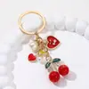 Llavero de Cereza Dulce Corazón con Cierre de Langosta Perla Pedrería Moño Colgante para Mochila de Niña de las Flores Venta al por Mayor