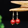 Venta al por mayor de fábrica alto contenido arena de oro púrpura aretes colgantes de cinabrio de alta gama de moda de lujo ligero para mujer aretes de rosa