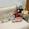Bolsa de Mão Estilosa Individual Tendência com Cordão Textura Lichia Formato Balde Moda Primavera/Verão 2026 Versátil Ombro Transversal