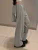 Pantalones casuales de pierna ancha estilo retro americano 2026 con detalle de lazo en la espalda, cintura elástica y diseño hasta el suelo, presentando un look único y elegante
