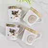Tazas de porcelana de hueso de lujo con borde dorado, perfectas para regalos de empresa o de inauguración de casa.