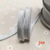En stock 48 colores poliéster velcro con borde de cordón ribeteado tira de inserción de cuerda para ropa colchas sofás cojines tira de ribete