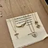 Bestseller de Xiaohongshu Set de Cuatro Piezas Concha Corazón Circonita Cruz Sonriente Circonita Trébol de Cuatro Hojas Colección Dropshipping