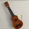 Ukelele para niños guitarra pequeña puede tocar grande, mediano y pequeño simulación niños y niñas Instrumentos musicales y juguetes para bebés al por mayor