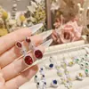 Brincos de camélia francesa brilhante com rubi simulado, banhados a ouro 18K, elegantes e nobres, com argola aberta.
