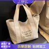 Bolsa de Lona para Mujer 2026 Modelo Nuevo Bolso Tote Grande de Moda Versátil Estilo Ins Bolso de Hombro para Clase y Viajes