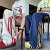 Pantalones deportivos de retazos a rayas estilo retro americano de seda helada de secado rápido, pantalones rectos holgados de moda de alta costura, pantalones casuales para adolescentes