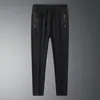 Calças de Seda Gelada Masculinas de Verão Calças Elásticas Respiráveis Calças Esportivas Masculinas para Exterior Tamanho Grande Soltas Calças de Secagem Rápida LOGO Imprimível