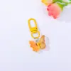 Pingente de chaveiro de borboleta de resina em cores vibrantes, acessório DIY para decoração de mochila, atacado do fabricante