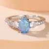 Anel Rongxing Cruz Quatro Garras Safira Azul Sintética Lateral Densamente Cravejado com Diamantes Brancos Simples Versátil Feminino