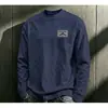 Camiseta de algodón de manga larga a la moda estilo americano para hombre, nueva colección otoño 2026, capa base casual y versátil de corte holgado para hombre