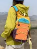 Mochila ligera y transpirable con diseño de bloques de color estilo montaña para estudiantes universitarias, adecuada para senderismo, ciclismo y camping