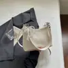 Bolsa de balde com padrão trançado de nicho francês para mulheres, nova moda 2026, bolsa de ombro estilosa, bolsa transversal versátil e simples
