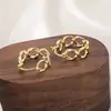 Pendientes de metal retorcido de diseño moderno, sencillo y exageradamente únicos, con un aire europeo y americano, versátiles nuevos pendientes de corazón hueco