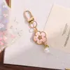 Nuevo llavero colgante de flor de esmalte colorido estilo INS, un accesorio de aleación de cara sonriente de doble cara creativo y versátil para DIY