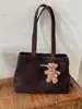 Bolso grande estilo universitario para mujer 2025 nueva moda versátil de un solo hombro simple para clase y desplazamientos bolso tote