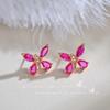Nuevos aretes de botón de mariposa color verde oliva Zircón corindón rojo sintético aretes de moda de lujo ligero nicho alta gama femeninos