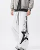 Pantalones de paracaidista casuales estilo americano con estampado de letras y estrellas para hombre y mujer, pantalones anchos de pierna recta ligeros de verano, ajuste holgado, con curva