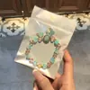 Libro Caperucita Roja Mismo Estilo Estudiante Pulsera de Glaseado de Palomitas de Maíz Hecha a Mano con Cuentas Dibujos Animados Cristal Pulsera Infantil Venta al por Mayor Cajas de Regalo