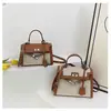 Bolsos estilo nuevo candado bolso Kelly, bolso de mano de moda europeo y americano con bloques de color para mujer, bolso cruzado de hombro texturizado y empalmado
