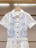 Vestido de Verano Nuevo de Alta Gama para Mujer Estilo Francés Delgado Bordado Hueco de Manga Corta de un Solo Botón en Shenzhen Nanyou