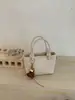 Bolso tipo cubo de tejido de alta gama para mujer, nuevo y elegante, estilo verano chic, de un solo hombro y cruzado