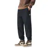 Pantalones casuales grises de otoño para hombre, corte holgado, con puño, pantalones de nueve puntos, marca de moda nueva 2026, pantalones deportivos tipo harén con retazos