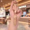 Bestseller transfronterizo creativo llavero colgante de arcilla con pedrería de micrófono lindo micrófono 3D tachonado de pedrería accesorio para bolso