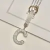 Pingente de chaveiro de carro com 26 letras em inglês cravejado de diamantes transfronteiriço, decoração de bolsa com strass de argila, atacado de chaveiro de celular