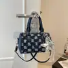 Bolsa de mano con textura de alta calidad al por mayor, bolsa tipo almohada, bolso para mujer, nuevo de otoño 2026, bolso de hombro de mezclilla a cuadros, bolso cruzado para el trabajo
