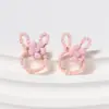 Pendientes de botón de aleación con cabeza de conejo de dibujos animados dulces y lindos estilo coreano con cuentas de arroz, pendientes simples, frescos y versátiles