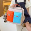 Mochila nueva de primaria sencilla de gran capacidad Bolso de mano para niños bolsa de maquillaje multifuncional color mochila pequeña al por mayor
