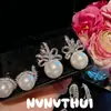 Set de Banquete de Joyería Pendientes de perla blanco roto con forma de cinta incrustados con diamantes Colgantes de oreja de perla de concha de girasol con detalles de diamante