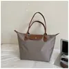 Nueva Tela Oxford Moda Versátil Gran Capacidad Impermeable Hombro Único Bolso tipo Dumpling Mamá Dama Nylon Viaje Bolso de Mano