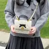 Mini bolso infantil 2026 otoño/invierno acolchado dulce cuadrado pequeño bolso de moda lazo padre-hijo PU bandolera